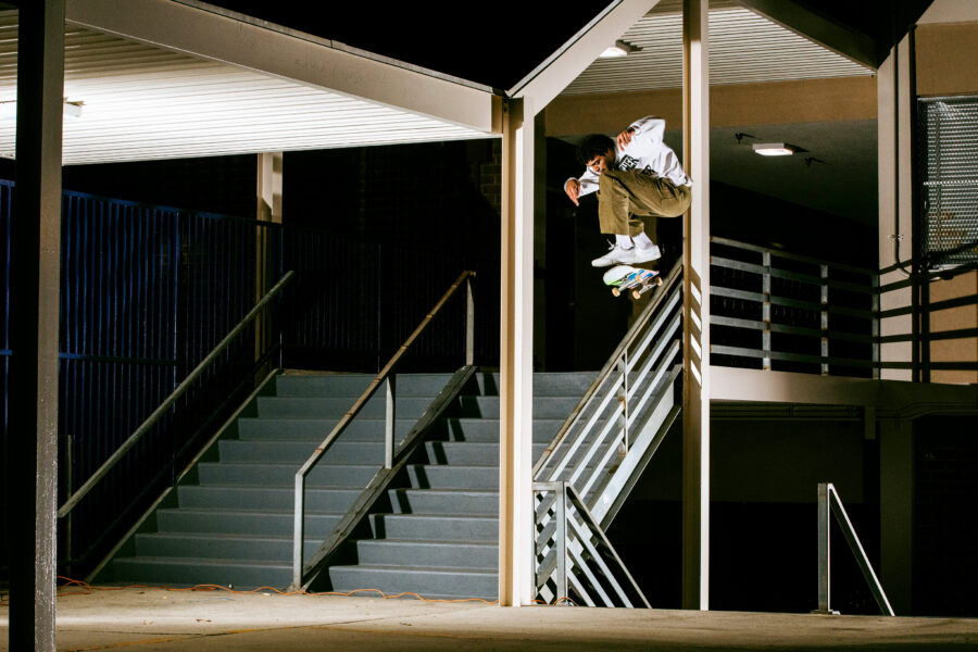 Justin Henry nollie kickflips over a handrail whilst weaving between two bars. Photo by Dakota Mullins.