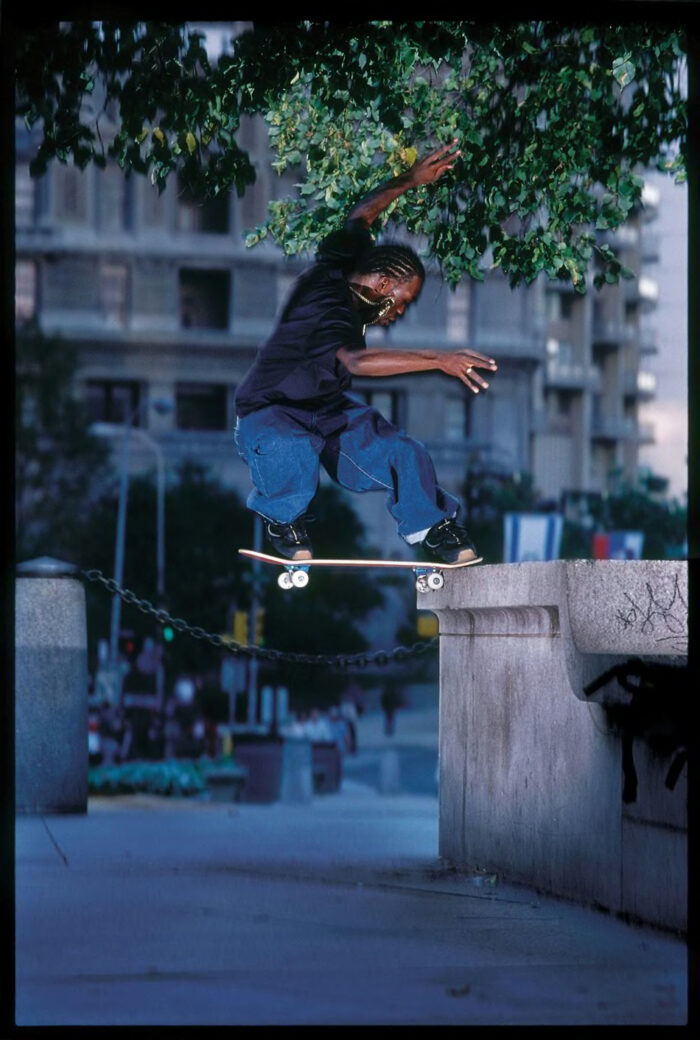 Stevie Williams – switch frontside noseslide on a tall ledge at Love Park shot by Mike Blabac. Clicking the image opens a new tab of the photograph in Mike Blabac's webstore.