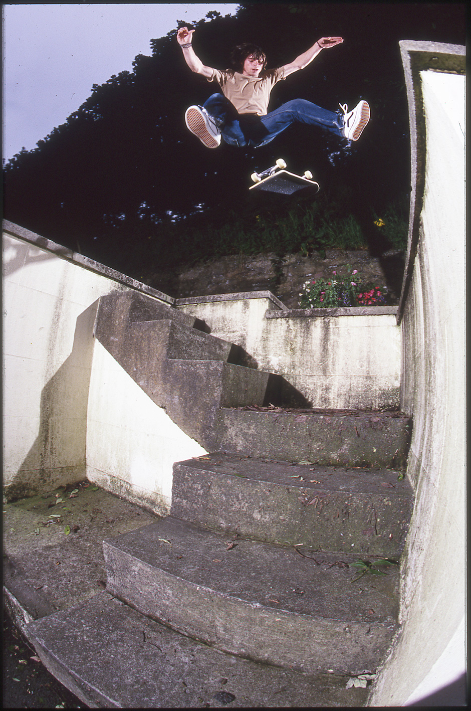 Olly Todd varial heelflips a staircase. Shot by Leo Sharp