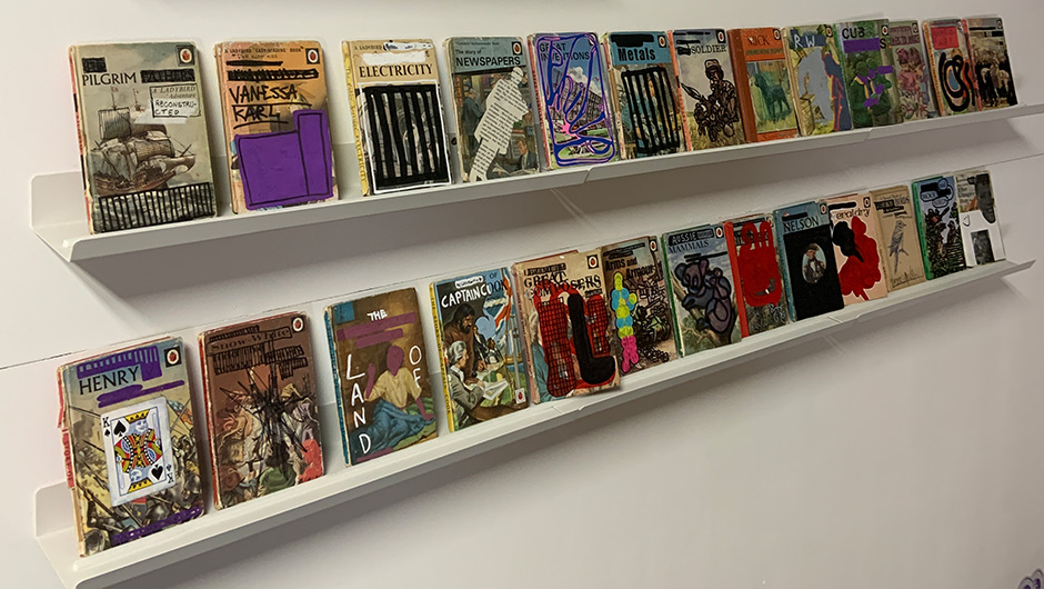 A long row of reconstructed Ladybird books at Tygar Smith's 'Thank you Very Much Ladybird' show for the Clown Skateboards x Tygar Miles Smith board series release