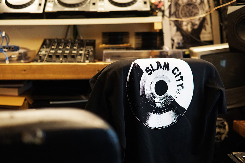 The black Slam City Skates X Rough Trade T-Shirt on the back of a chair in the studio