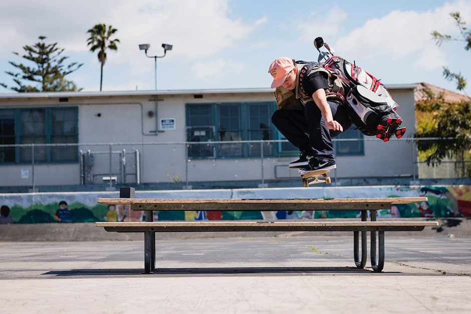 Cory Kennedy ollies a picnic table at Gardener with a golf bag on his back. Photo shot by Ben Colen