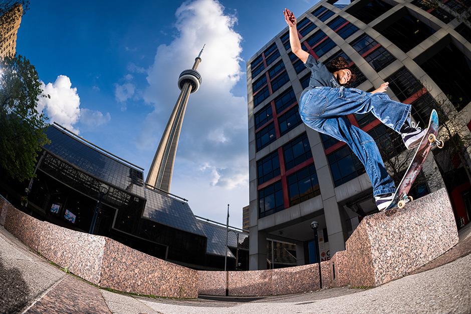 Arin Lester frontside 180s a gap to fakie nosegrind beneath the CN Tower in Toronto the day she turned pro. Photo shot by Kyle Seidler and selected for his Slam City Skates 5000 Words interview